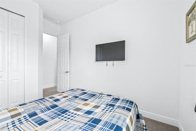 carpeted bedroom featuring a closet