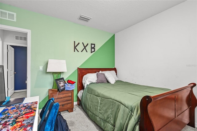 carpeted bedroom with a textured ceiling