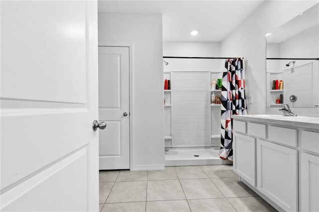 bathroom with a shower with curtain, tile patterned floors, and vanity