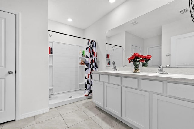 bathroom featuring curtained shower, vanity, and tile patterned floors