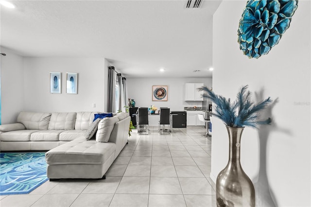 living room with light tile patterned flooring and a textured ceiling