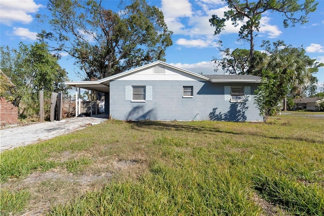 view of property exterior featuring a carport and a lawn