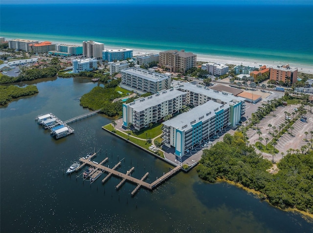 birds eye view of property with a water view and a view of the beach