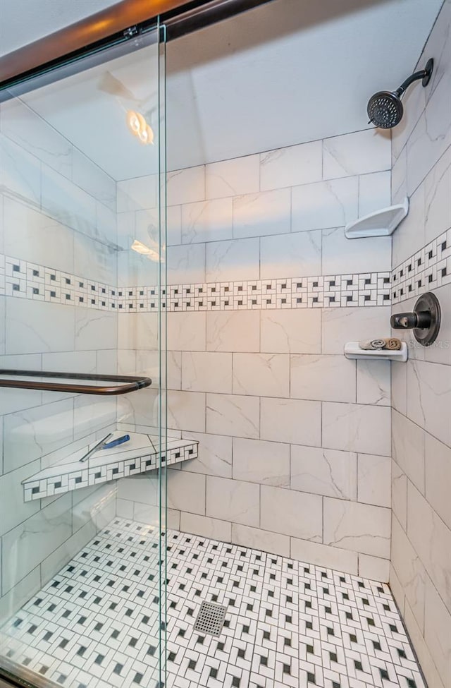 bathroom with a shower with shower door