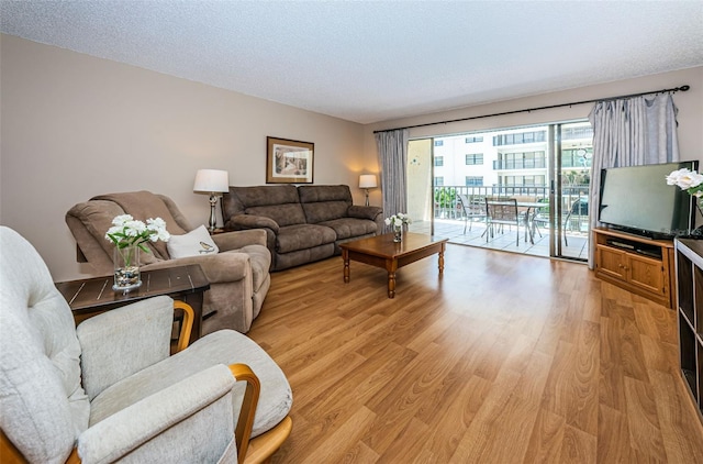 living area featuring a textured ceiling and light wood-style floors