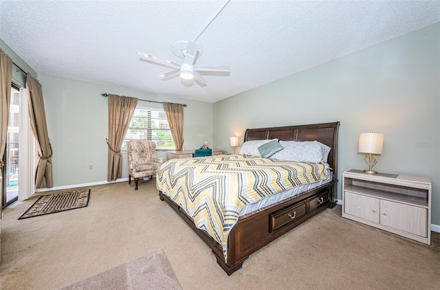 bedroom featuring ceiling fan, a textured ceiling, and carpet floors