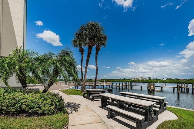 view of community featuring a dock and a water view