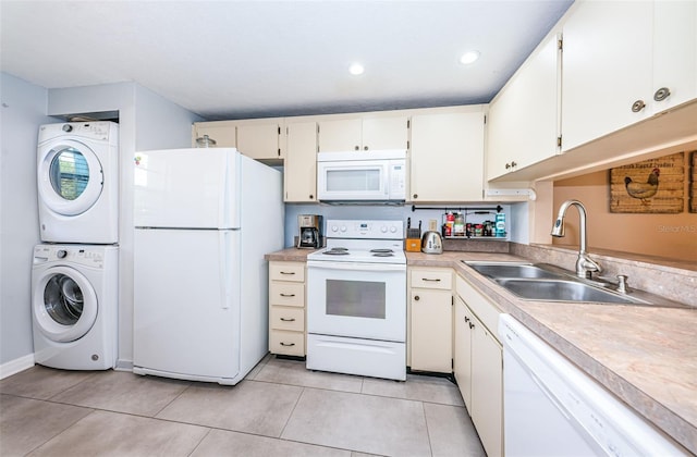 kitchen featuring stacked washer / dryer, white appliances, sink, and light tile patterned floors