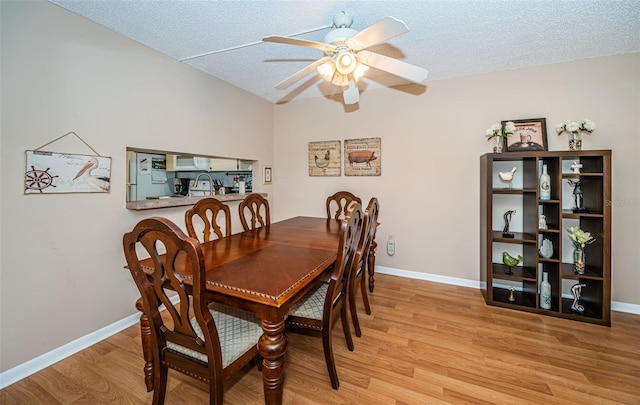 dining area featuring wood finished floors, baseboards, and ceiling fan