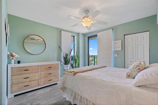 bedroom featuring light wood finished floors, visible vents, a closet, a ceiling fan, and access to outside