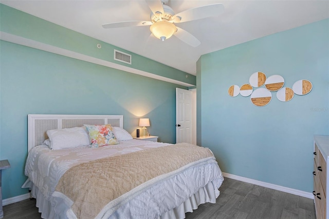 bedroom featuring ceiling fan, wood finished floors, visible vents, and baseboards