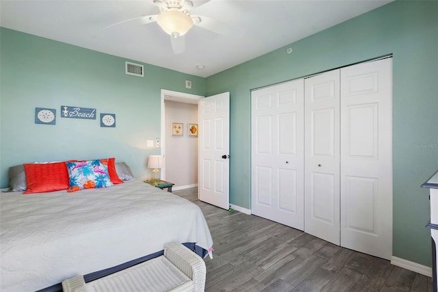 bedroom featuring a closet, visible vents, baseboards, and wood finished floors