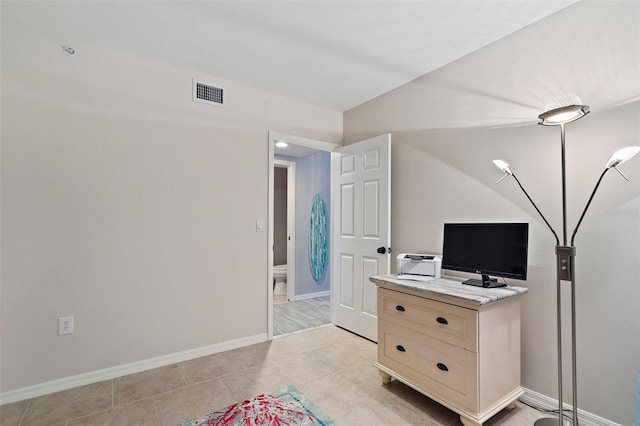 bedroom with light tile patterned floors, visible vents, and baseboards