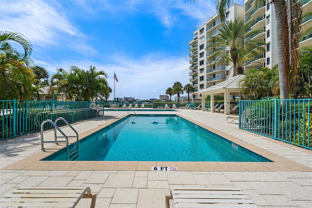 pool featuring a gazebo, a patio area, and fence