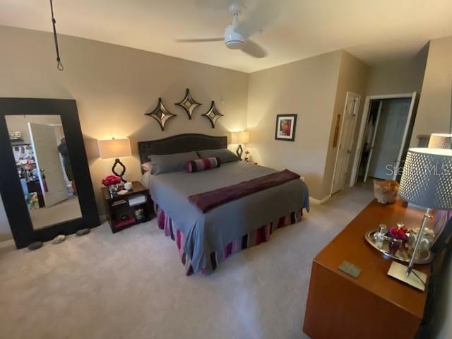 carpeted bedroom with ceiling fan