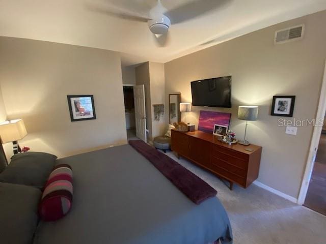 bedroom with ceiling fan and light carpet