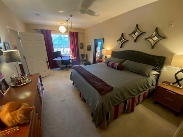 carpeted bedroom featuring ceiling fan