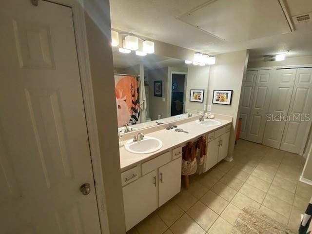 bathroom featuring vanity, tile patterned floors, and walk in shower