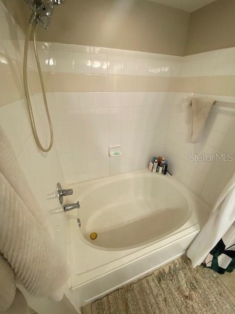 bathroom with shower / tub combo with curtain