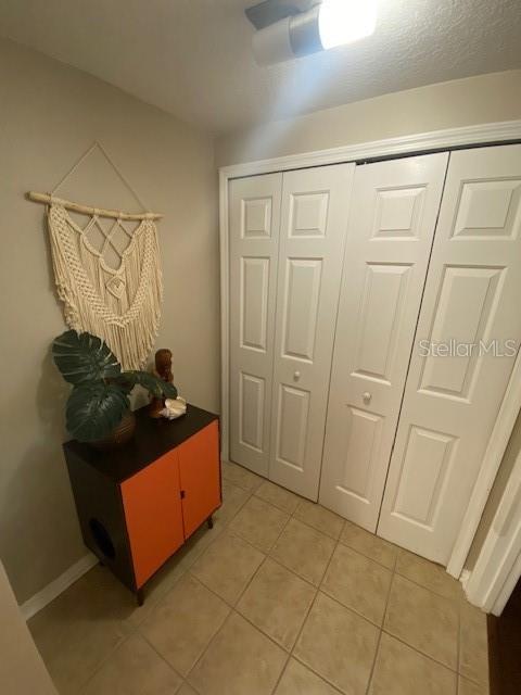 hallway with light tile patterned floors