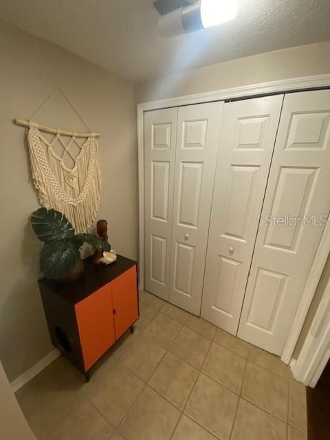 hallway with tile patterned floors