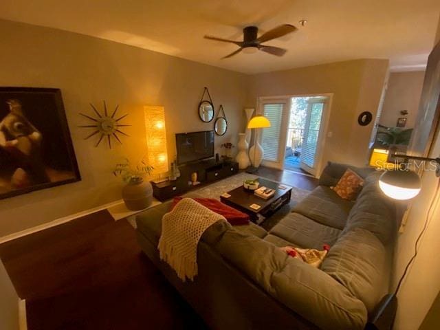 living room with ceiling fan and wood-type flooring