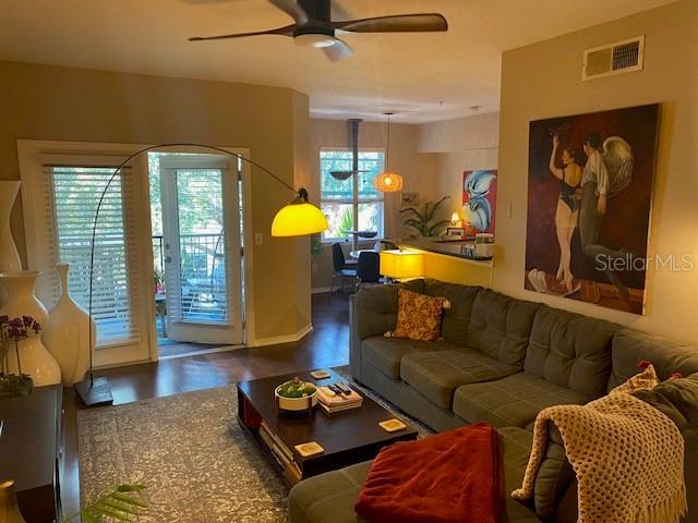 living room featuring hardwood / wood-style floors, plenty of natural light, and ceiling fan