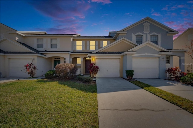 view of front of home featuring a lawn and a garage