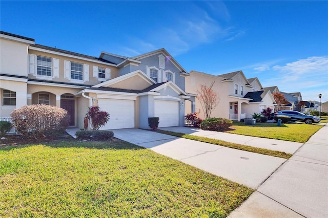 view of front of property featuring a front yard and a garage