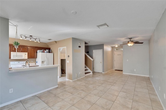 kitchen featuring white appliances, ceiling fan, light tile patterned floors, and kitchen peninsula