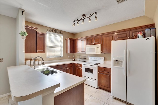 kitchen with white appliances, kitchen peninsula, light tile patterned floors, a textured ceiling, and sink