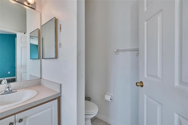 bathroom with toilet, tile patterned flooring, and vanity