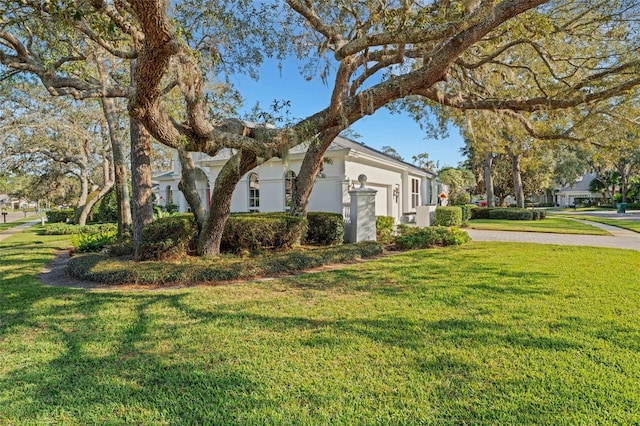 view of side of property with a lawn