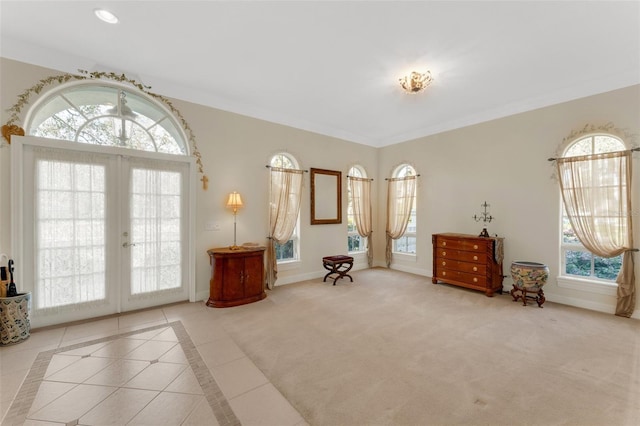 living area with french doors, plenty of natural light, and light tile patterned floors