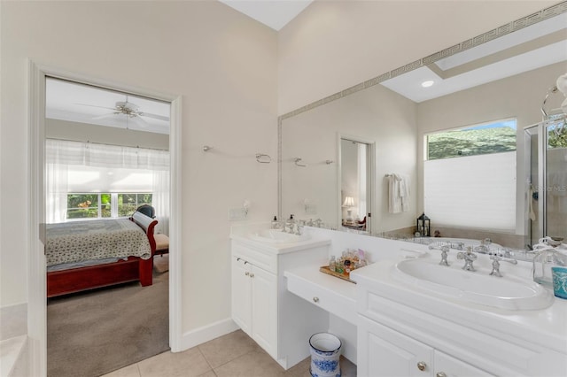 bathroom with tile patterned flooring, ceiling fan, a healthy amount of sunlight, and vanity