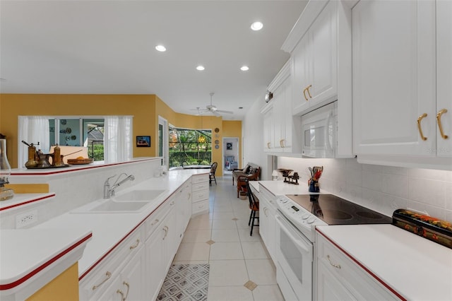 kitchen featuring white appliances, decorative backsplash, white cabinetry, light tile patterned flooring, and sink