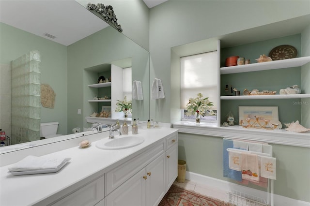 bathroom featuring toilet, vanity, and tile patterned floors