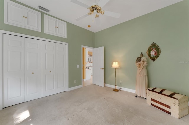 unfurnished bedroom featuring light colored carpet, ceiling fan, and a closet