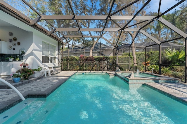 view of swimming pool featuring an in ground hot tub, glass enclosure, and a patio