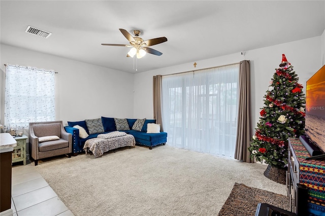 tiled living room with ceiling fan