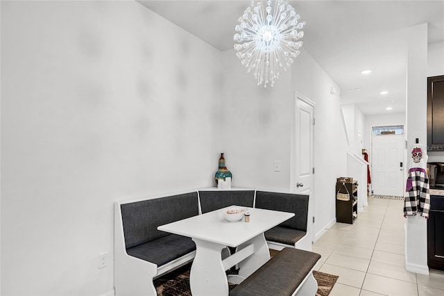 tiled dining area featuring a notable chandelier and breakfast area