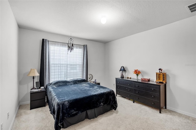 carpeted bedroom with a textured ceiling