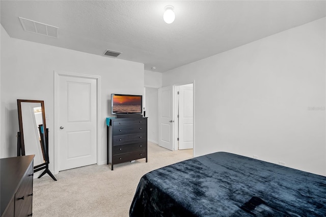 carpeted bedroom featuring a textured ceiling