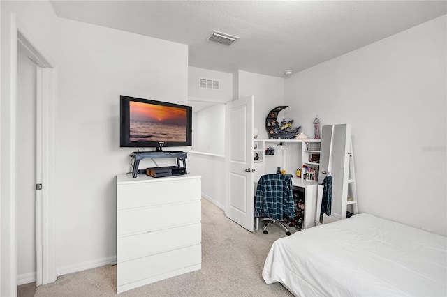 carpeted bedroom featuring a textured ceiling