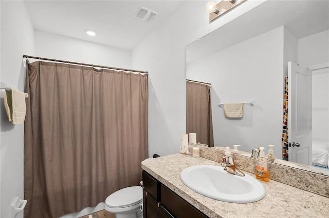 bathroom featuring vanity and toilet