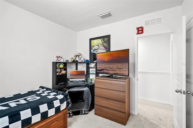 carpeted bedroom with a textured ceiling