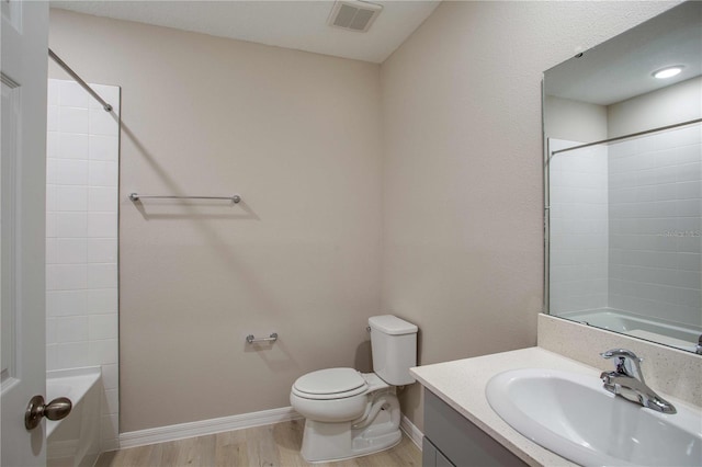 full bathroom with hardwood / wood-style floors, vanity, shower / bathtub combination, and toilet