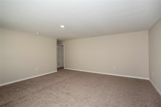 spare room with carpet and a textured ceiling