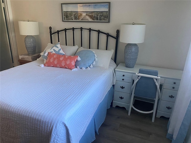 bedroom with dark hardwood / wood-style floors