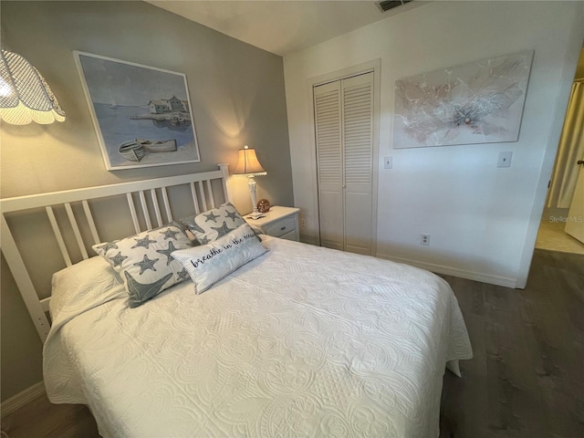 bedroom with a closet and hardwood / wood-style flooring